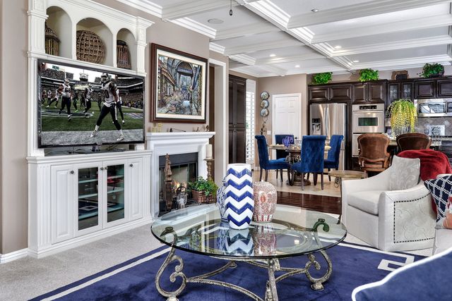 Living room with blue rug and built-in TV wall