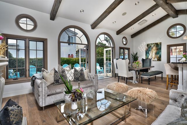 Living room with arched windows and wood beams