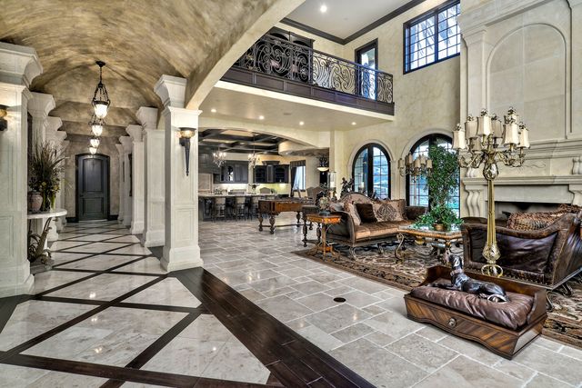 Grand entry hall with stone floor and arched ceilings