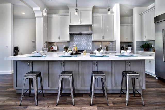 Kitchen with gray island and counter stools