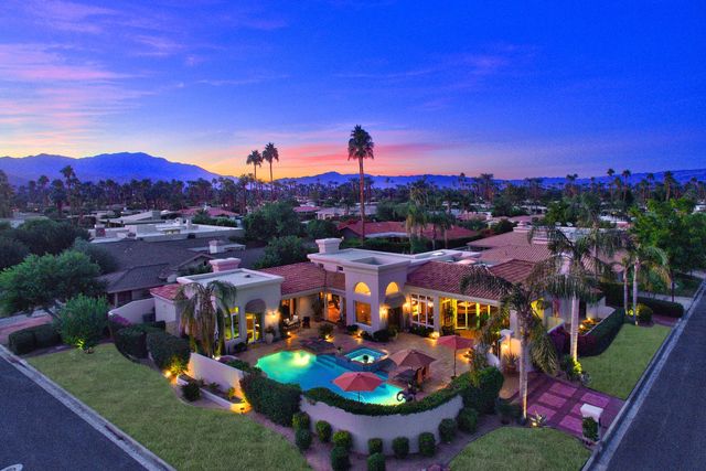 Aerial view of an estate with pool at twilight