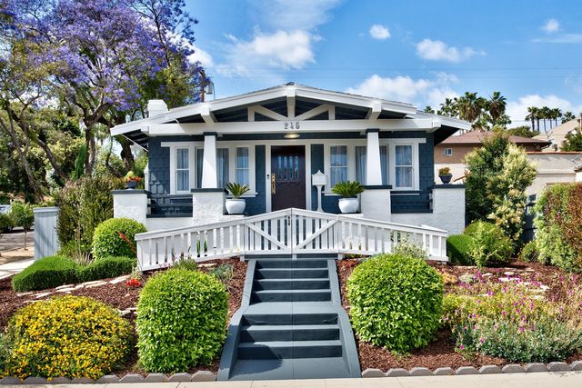 Craftsman home with front garden and steps