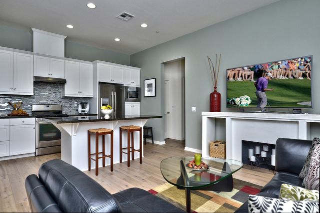Open kitchen and family room with leather sofas