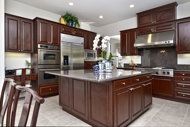 Kitchen with dark cabinets and granite island