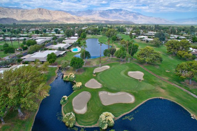 Aerial view of golf course fairways and pond