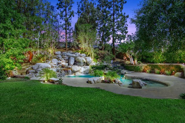 Backyard pond and waterfall at twilight