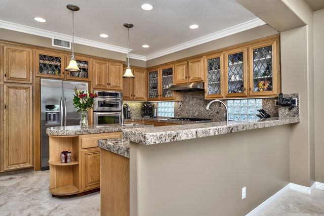 Kitchen with oak cabinets and granite counters