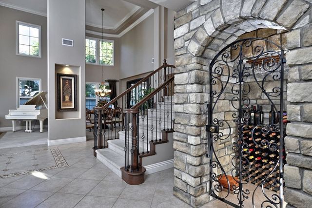Entry with staircase and glass-front wine cellar