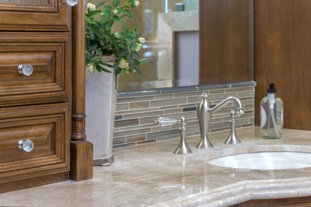Bathroom vanity detail with glass tile backsplash