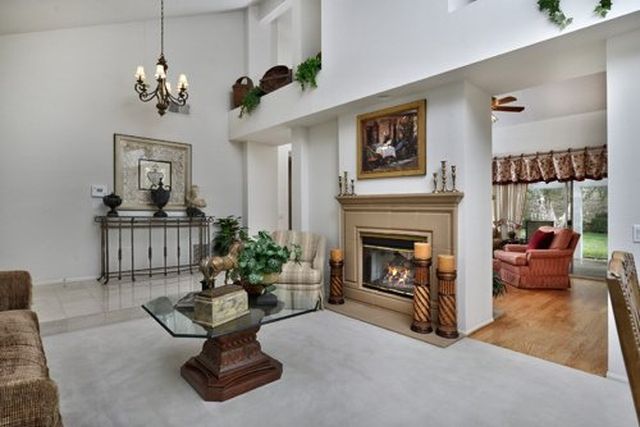 Living room with fireplace and high ceilings