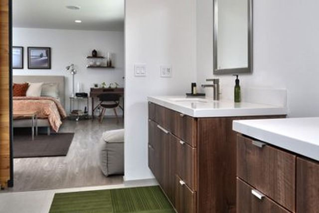 Bathroom vanity with green runner rug