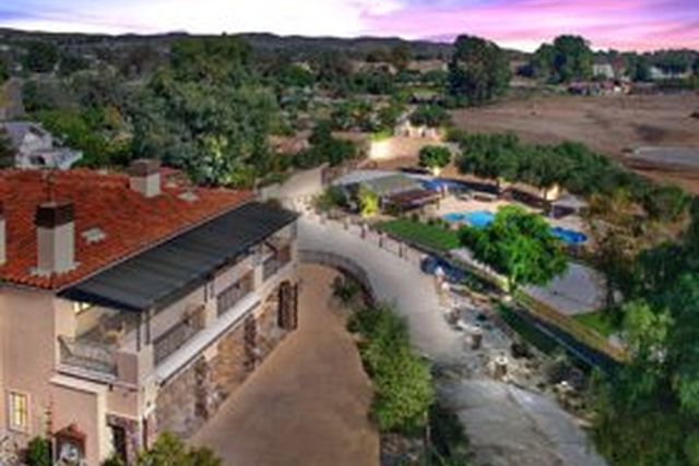 Aerial view of a hillside estate at dusk
