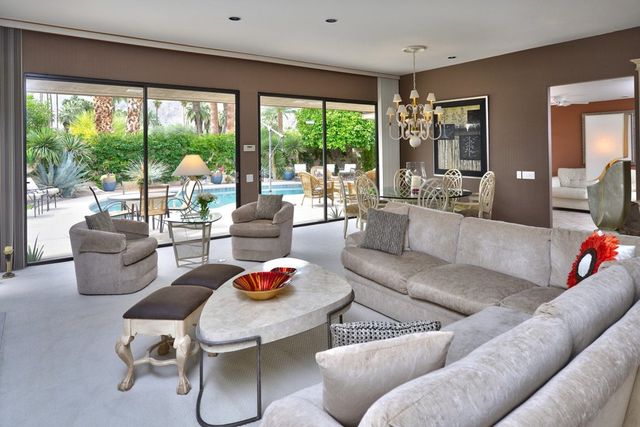 Living room with sectional sofa and sliding doors to the pool